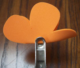 punch a hole in the middle by folding the flower in half.